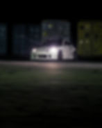 White sports car at night, photography portfolio entry.