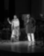 Two smiling singers on stage in a photography portfolio.