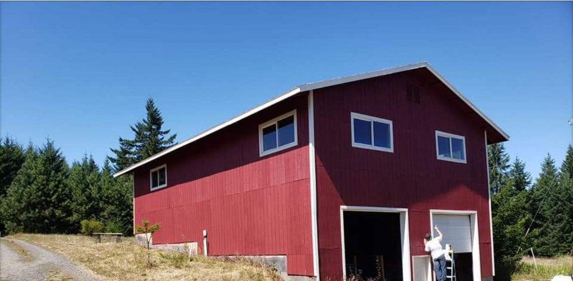 A barn with new red paint and white trim