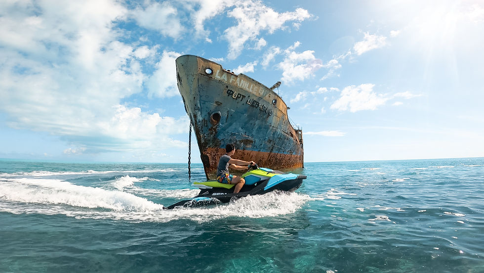 Tourists riding jet skis toward La Famille Express shipwreck in Providenciales, Turks and Caicos