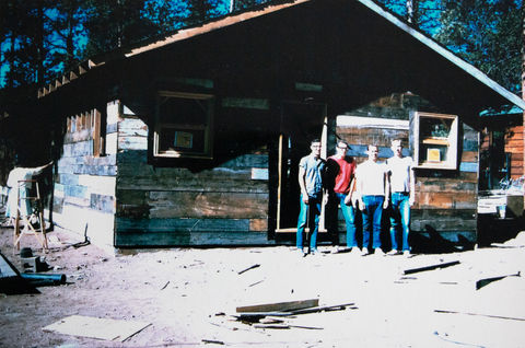 A group of men standing in front of the newly-built guest house