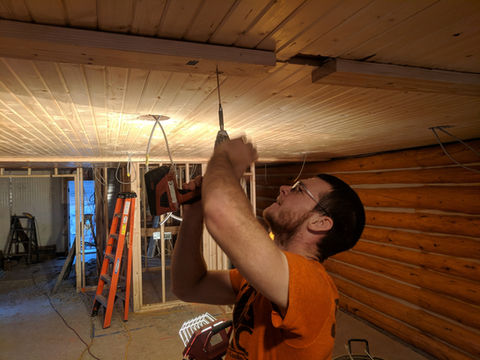 Photo of Alex renovating the ceiling in the south end of the main lodge