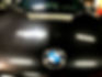 before and after of a paint correction on a black bmw suv