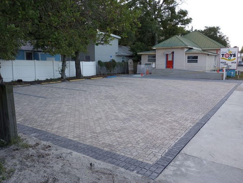 freshly paved parking lot with brick pavers