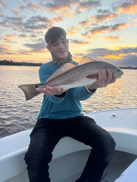 angler holding large bull redfish