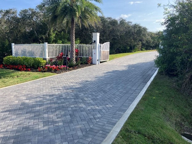gated residential driveway with paver bricks