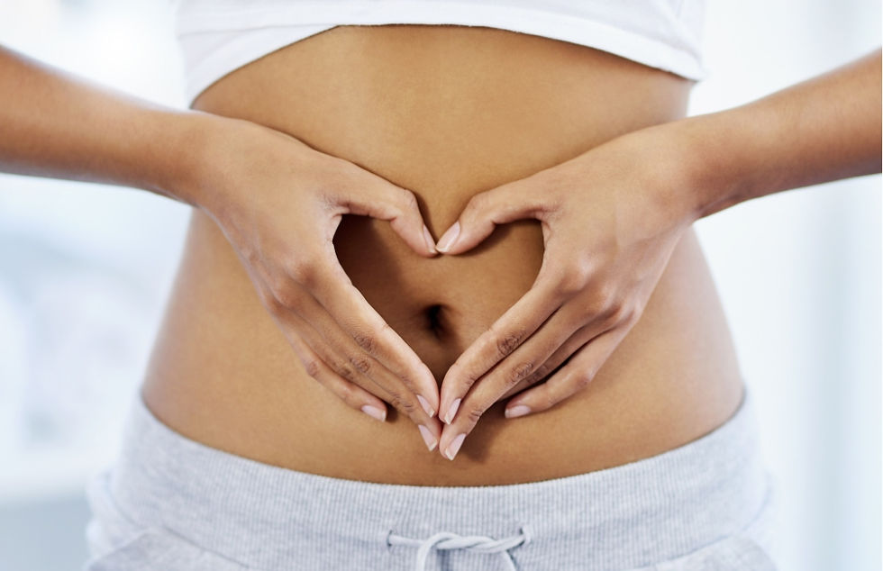 Love your gut. Image shows a woman making a heart symbol with her hands in front of her stomach