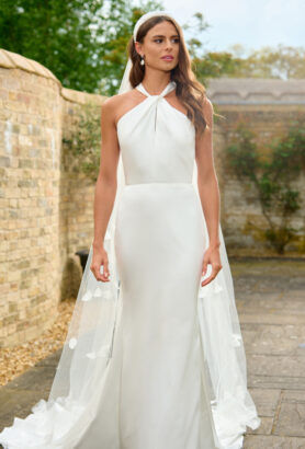 Like the Stella McCartney dress that Meghan Markle wore, Capri is a simple beautiful modern wedding dress that is pared-back in its design in a slinky satin with clean lines. The dress is fully lined in our softest satin for a luxurious feel on the body. A clever twist of fabric at the neck reveals a subtle keyhole neckline as you move. The statement halterneck bow on the back is revealed as you turn, for an elegant dress full of personality.