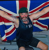 Exe Events guest speaker Lee Spencer holding up a union jack flag after crossing the atlantic ocean.
