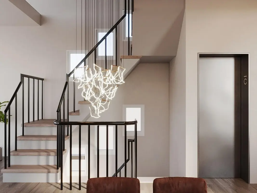 Elegant stairwell with a long chandelier cascading down multiple levels, featuring modern railing design and ambient lighting that enhances the architectural detail