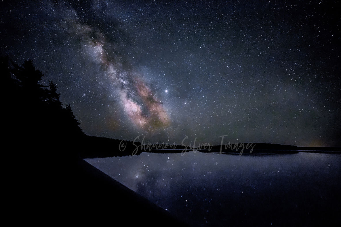 The Milky Way galaxy stretching across an indigo night sky.