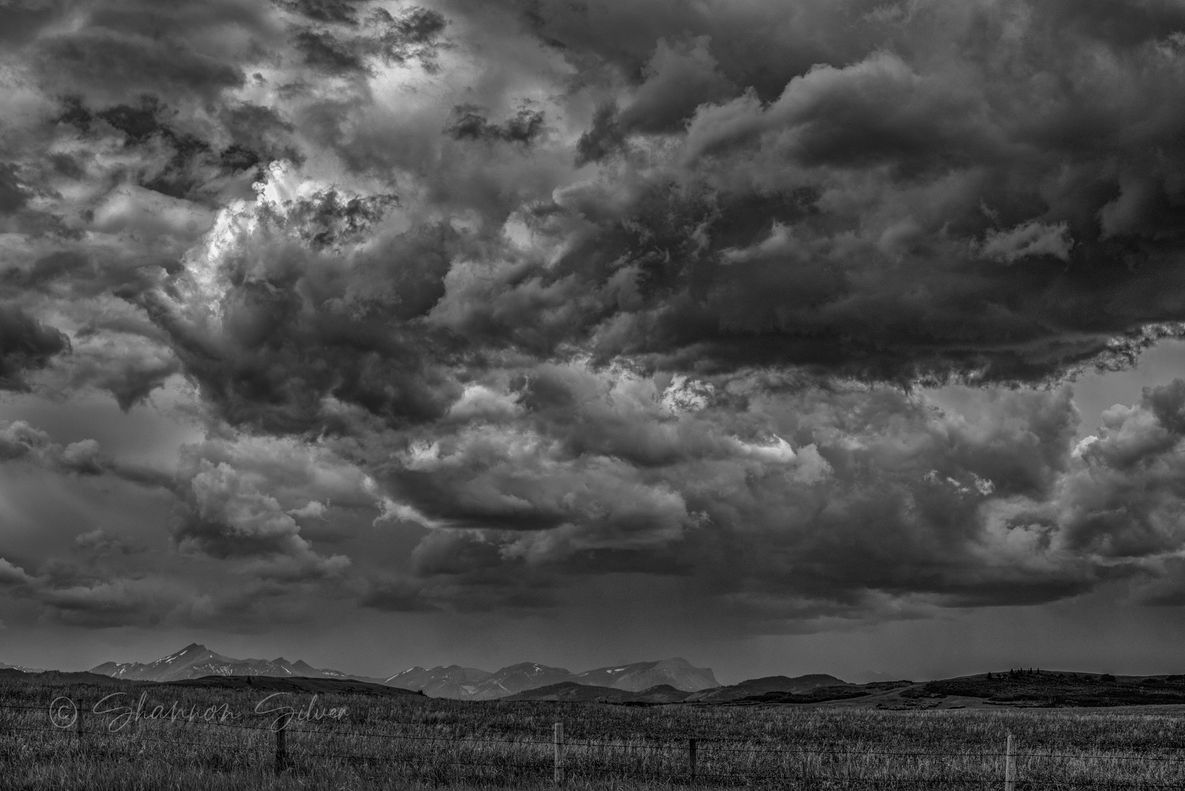 Spring storm clouds gathering over the foothills, in black and white
