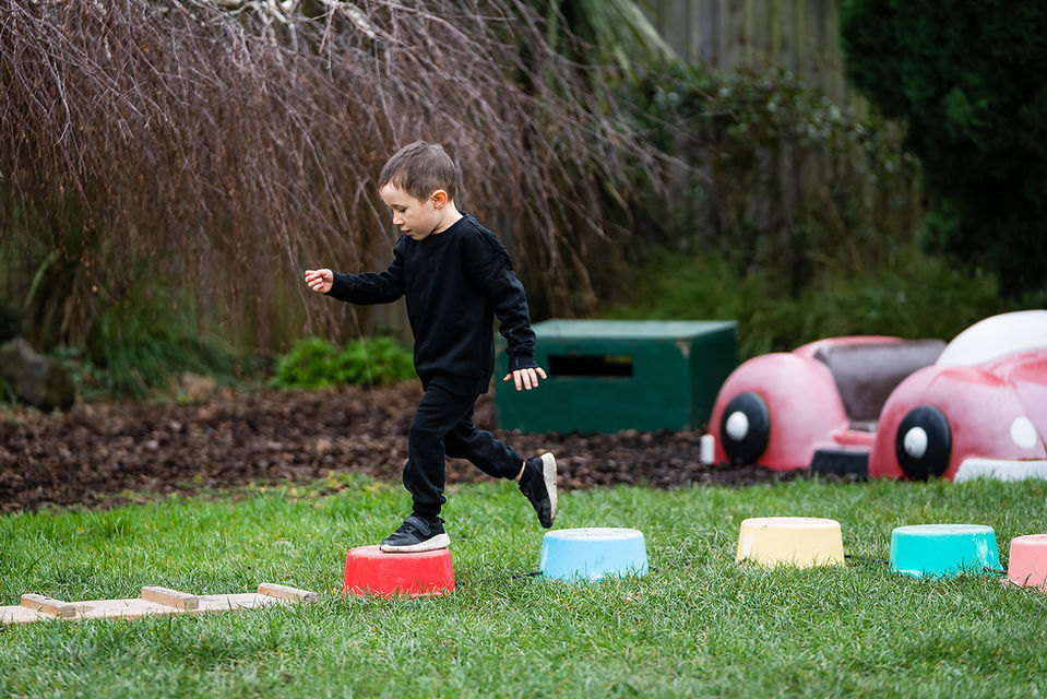 Boy playing jumping game at Edinburgh Street early learning centre in Spreydon
