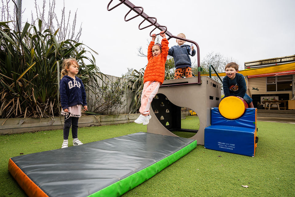 Playing on jungle gym with friends at kindy in Spreydon