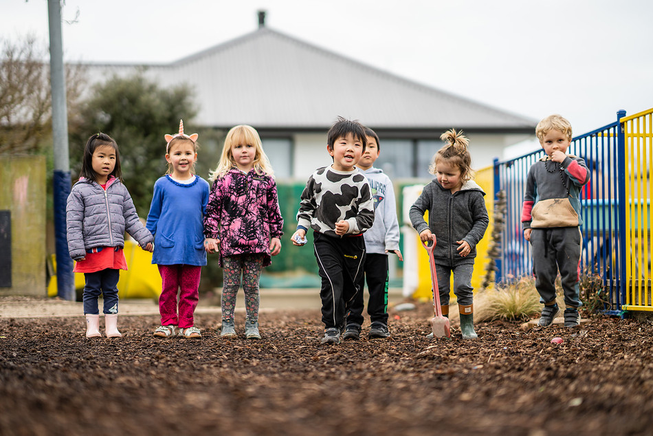 Group of kids lining up for a race on the soft bark play area