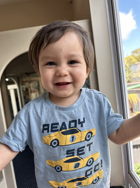 Boy laughing in Lyttelton street child's nursery school in Chch
