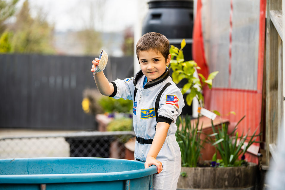 Boy dressed up as astronaut playing at kindy in Spredyon