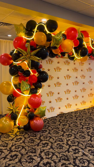 Hollywood-themed organic balloon garland with LED rope lights and gold stars for Oakwood Friends High School prom at Mill Creek Caterers Hopewell Junction NY