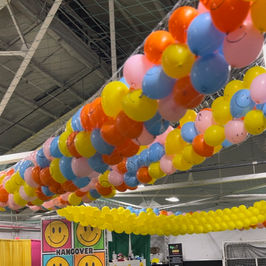 Colorful balloon drop with smiley faces and event decor in NYC.