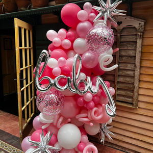 curved organic balloon column in hot pink and light pink with silver accents for baby shower in Greenwich Village NYC