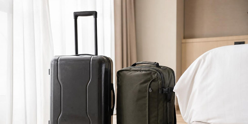 Hardside polycarbonate suitcase and softside nylon duffel bag side by side at an airport.