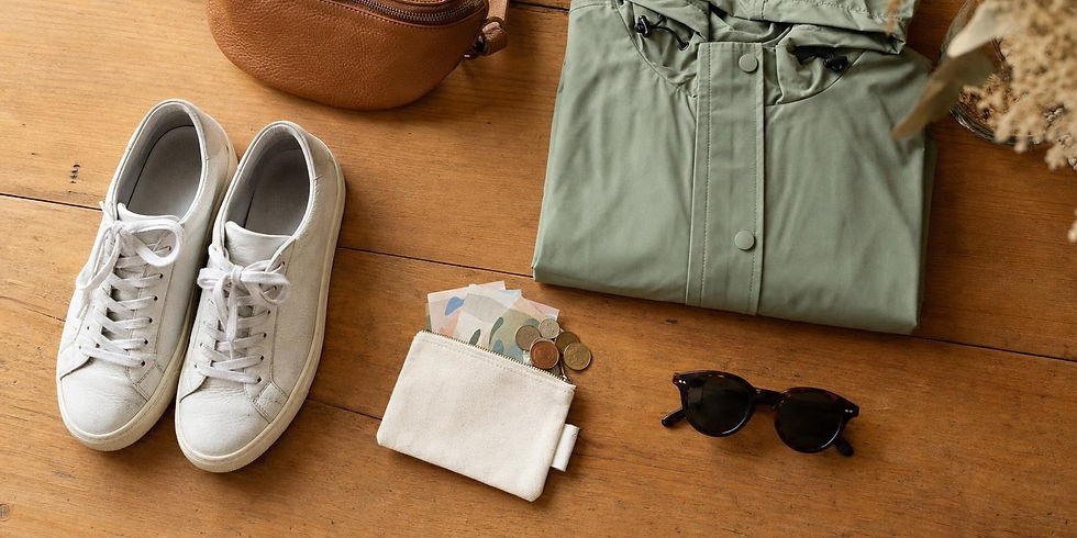 A small belt bag, comfortable shoes and a light jacket laid out for a festival day.