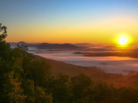 Layered Blue Ridge Mountains at sunrise in western North Carolina representing hope, reflection, and healing.