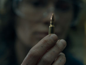 Lena Headey stands in an industrial setting in the revenge thriller Ballistic.
