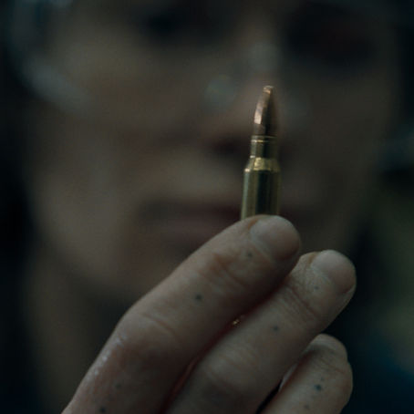 Lena Headey stands in an industrial setting in the revenge thriller Ballistic.