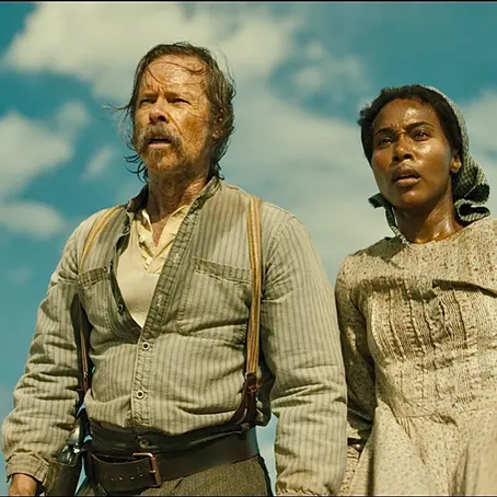 Still from Killing Faith showing DeWanda Wise as Sarah clutching her daughter against the harsh backdrop of the 1849 frontier, evoking the film’s blend of Western grit and supernatural dread.