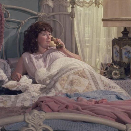 Still from The Cramps: A Period Piece showing Lauren Kitchen as Agnes Applewhite inside a beauty salon setting.