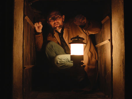 Adam Scott holding a lantern in the first look at Hocum.