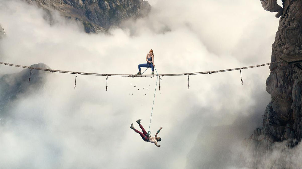 A climber hangs high above a rocky landscape in a scene from Fall 2: Deadpoint.