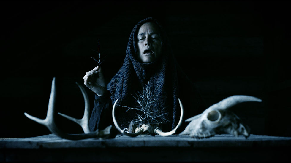 Still from Mother of Flies showing Zelda Adams in a haunting, nature-infused setting that reflects the film’s folk-horror atmosphere.