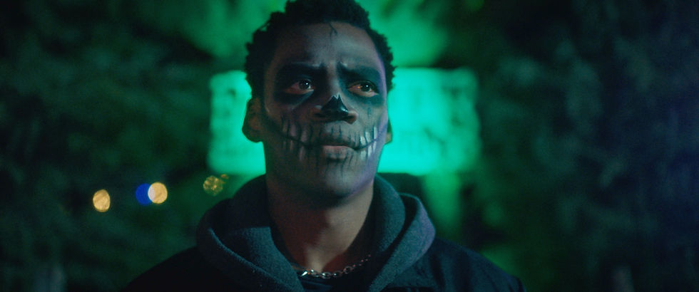 Grayson Gwaze stands inside a haunted attraction in The Haunted Forest trailer still.
