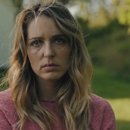 Jessica Rothe looking distressed in a dimly lit room in Affection