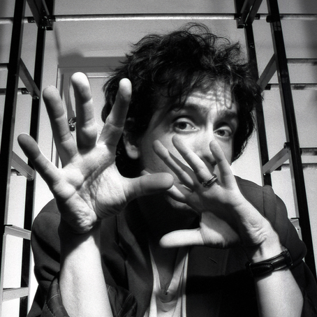Official poster for Tim Burton: Life in the Line featuring Burton surrounded by iconic characters from his films.