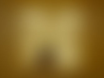 A person stands in a yellow, empty room under fluorescent lights.