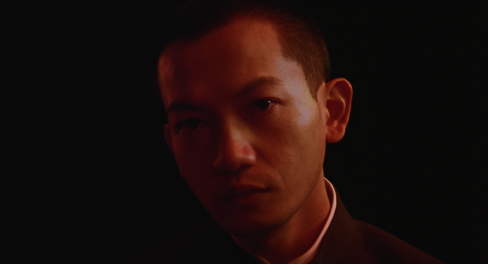 Still from A SOIL A CULTURE A RIVER A PEOPLE showing Citizen Yu in a replica of 1980s Hannover.