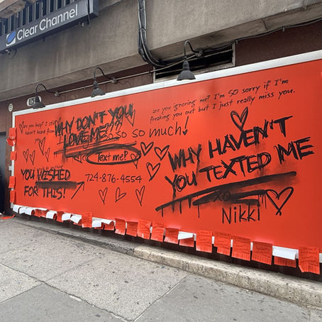 Creepy billboard in a city promoting the horror film Obsession with a phone number to text Nikki