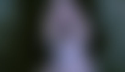 Poster for Our Happy Place showing a woman emerging from a shallow grave in a fog-drenched forest.