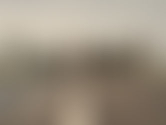 Still from The Long Walk featuring teenage contestants walking down a foggy road under military escort.