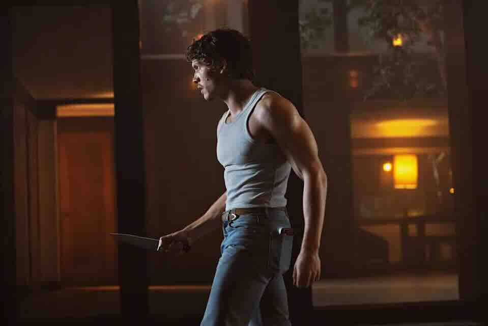 Connor Storrie in a dimly lit cabin during Verizon’s horror short directed by Nia DaCosta.