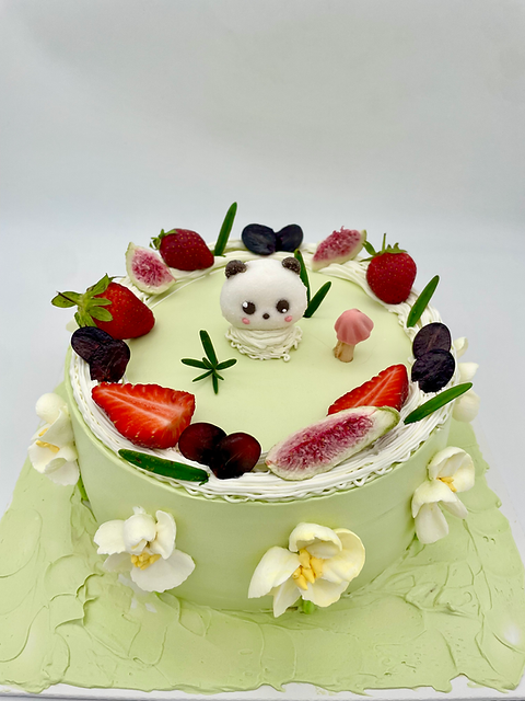 Green Birthday Cake with fresh fruit and a panda on top.