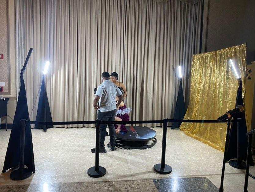 360 booth with a gold backdrop