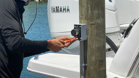 Luis installing an outlet on a piling for a private dock in St. Petersburg, FL – waterfront electrical installation