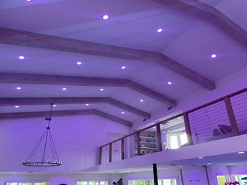 Purple recessed ceiling lights installed in a modern living room in Gulfport, FL – custom interior lighting design