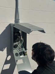 Luis, master electrician, inspecting a sub panel during a free electrical assessment for a store in Pinellas Park, Florida.