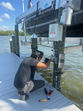 Luis, master electrician from Coastal Palms Electrical, inspecting a sub-panel on a private dock in Pinellas County, Florida.