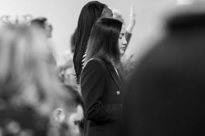 Woman praying with eyes closed at Eldad Elim Church